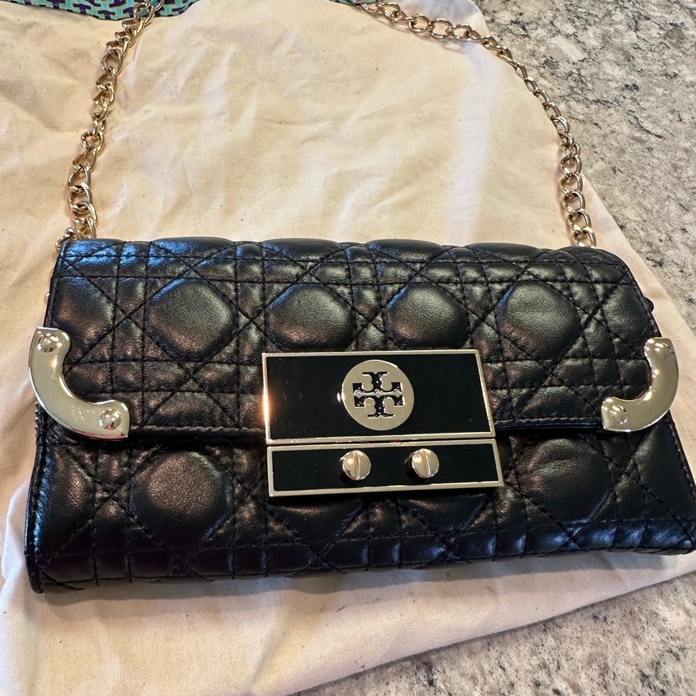 Tory Burch clutch bag with gold accessories.